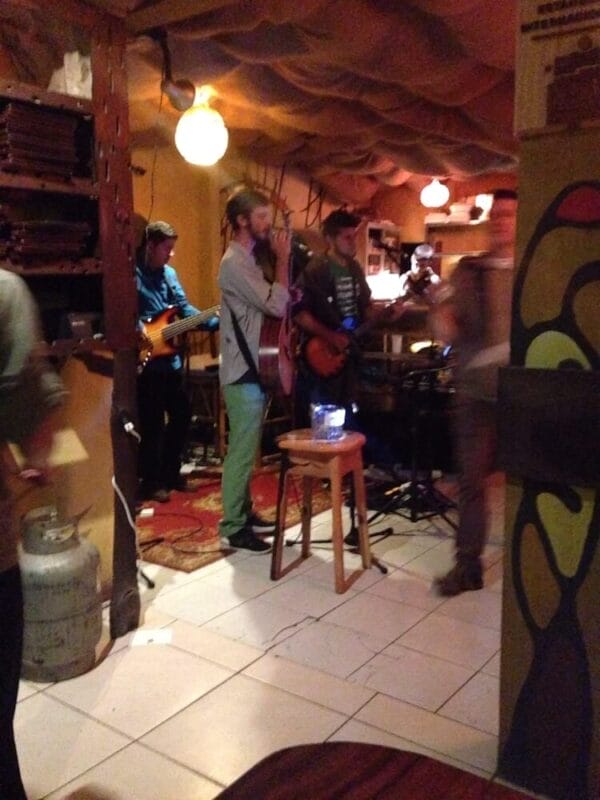 man singing with guitar in restaurant