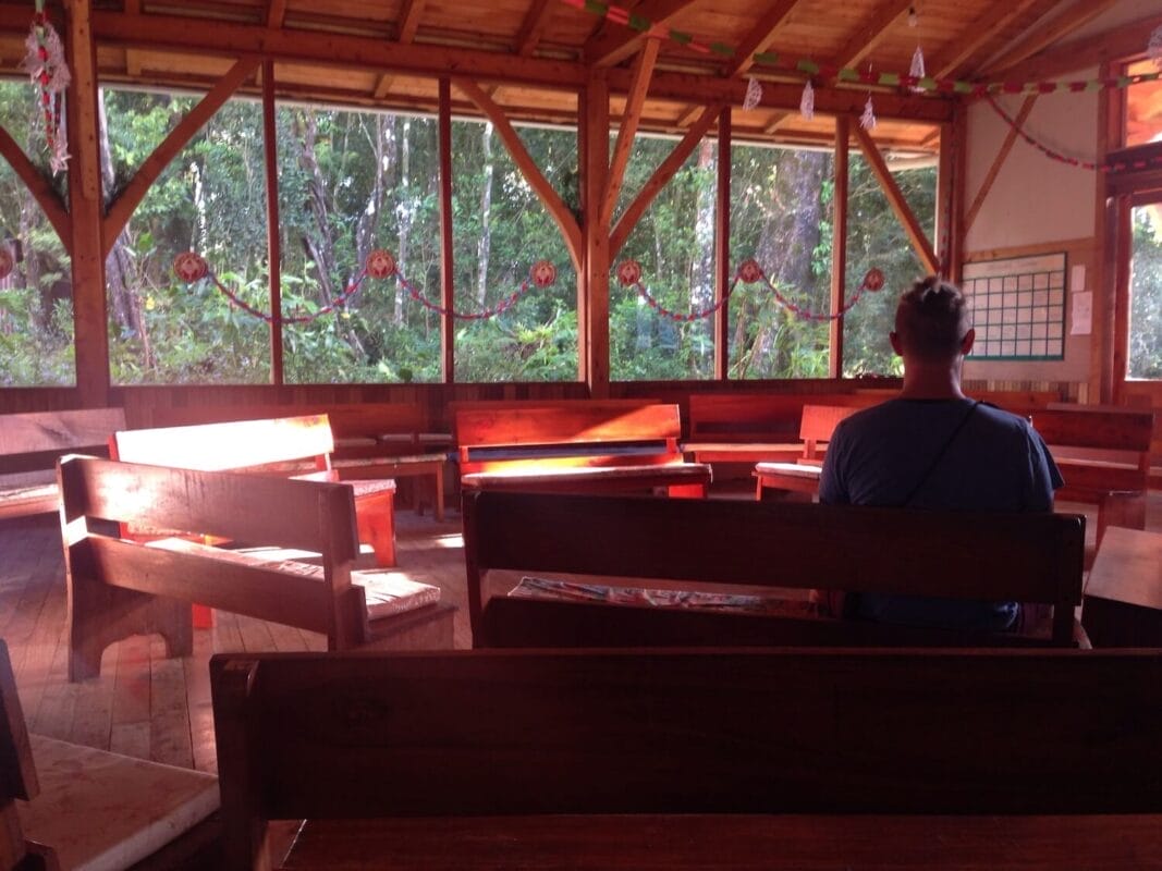 man sitting in empty meeting house