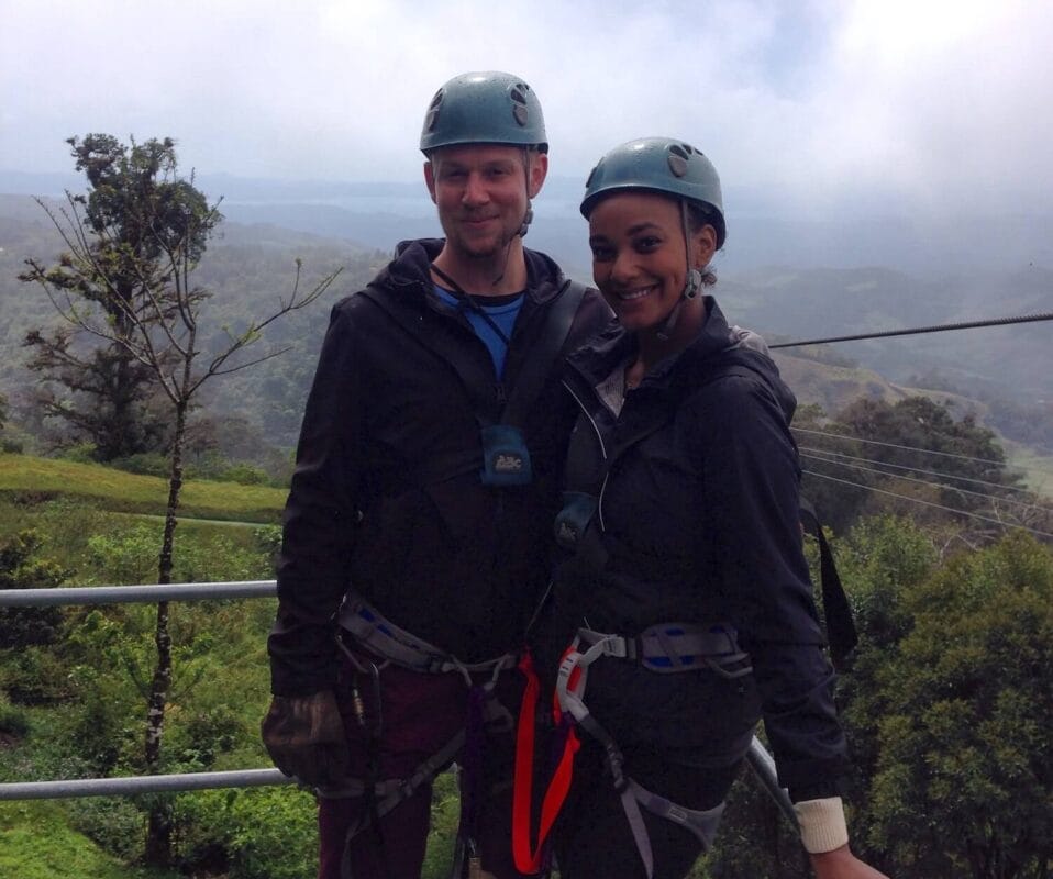 travel couple wearing helmet and zipline gear