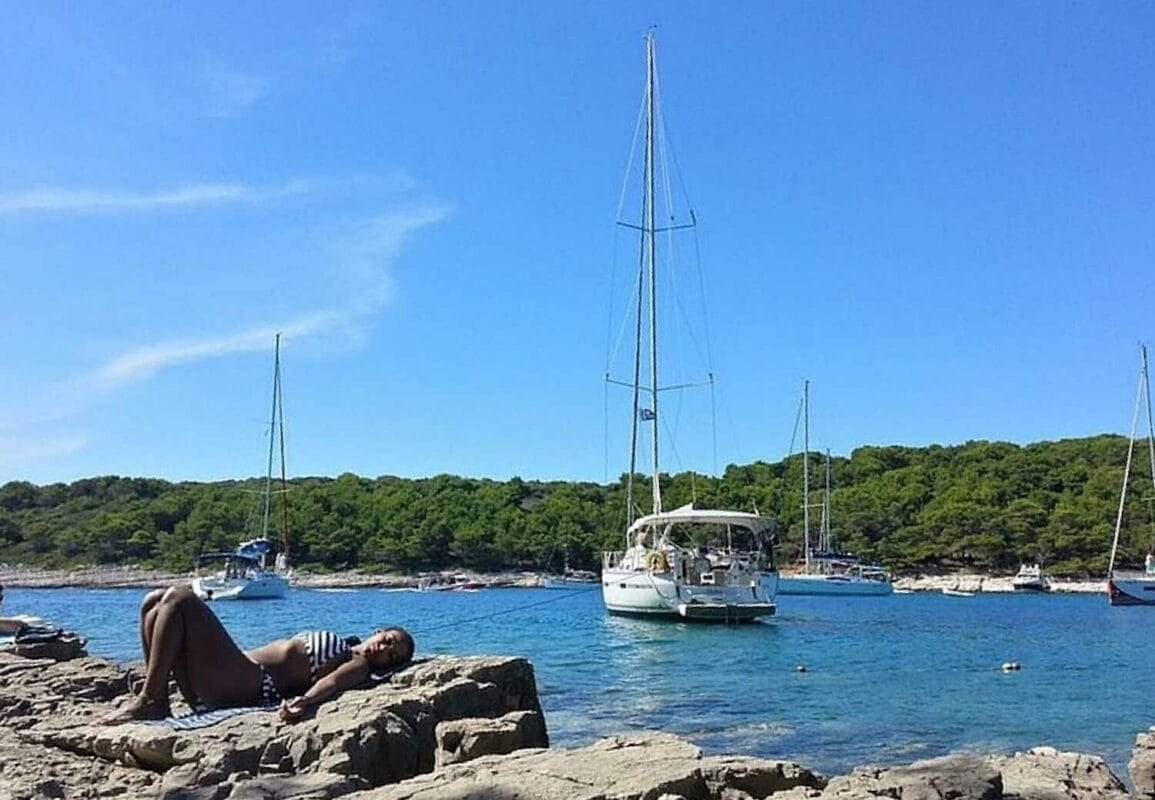 olivia sunbathing rocks water boat