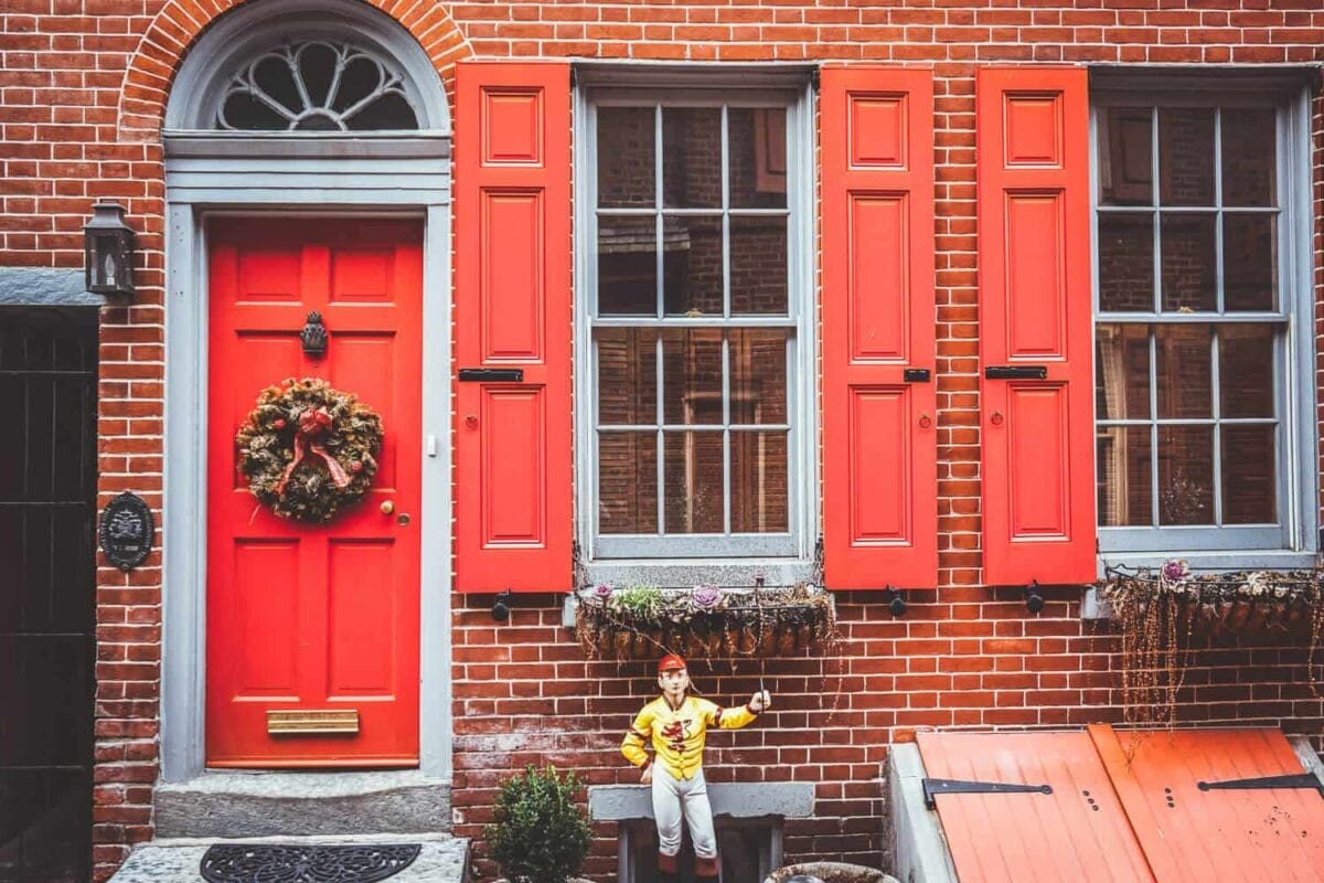 historic alley with red door and brick brownstone