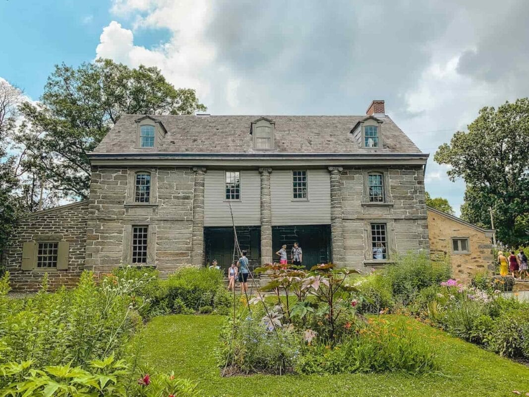 classic Pennsylvania dutch stone house in a garden