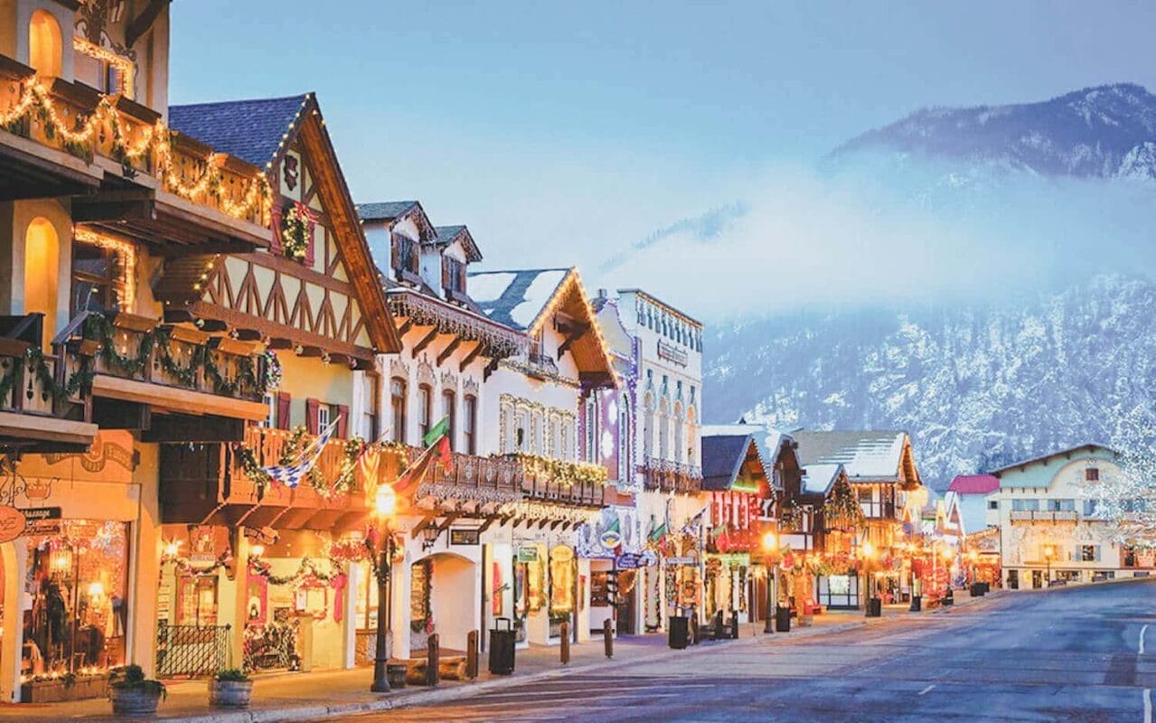 festive lighting on bavarian style houses with snow and mountains