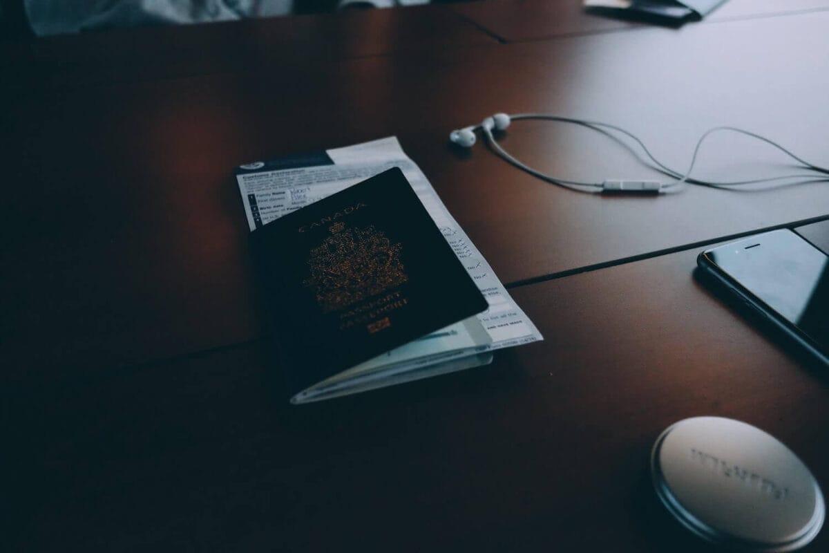 passport, immigration form, headphones on table