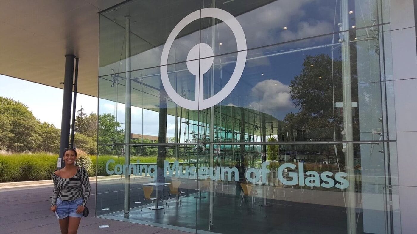 Large glass window and entrance sign of Corning museum of glass etched on it