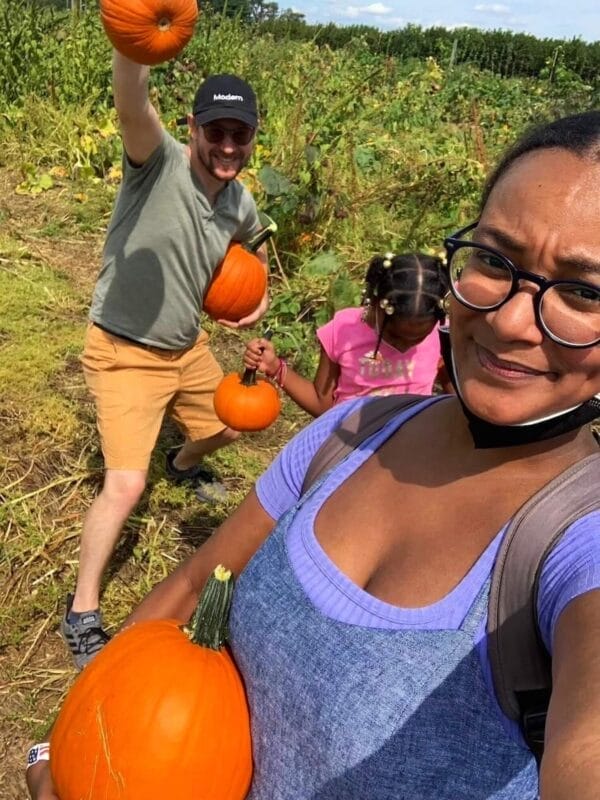 Family pumpkin picking in an orchard