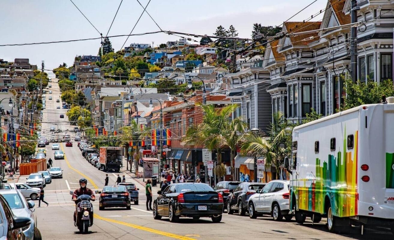 San Francisco city street with a large hill and Victorian houses