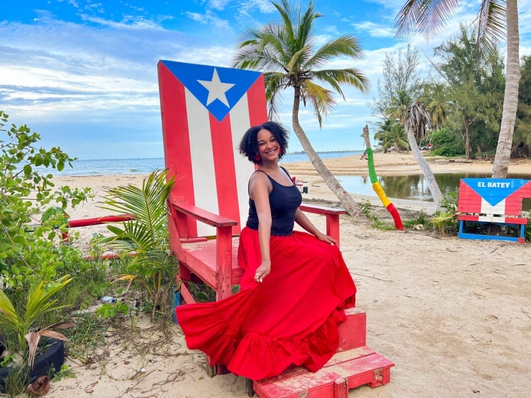 large Adirondack chair with the puerto rico flag painted on it at the beach