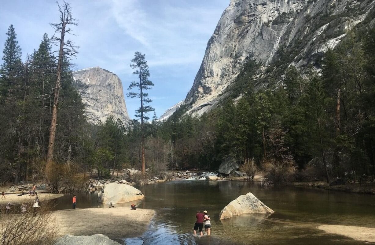 tourists walking around mirror lake in yosemite national park