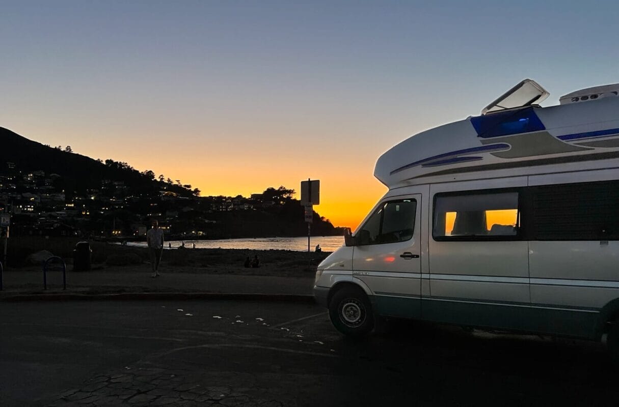 road trip campervan RV at sunset on the beach