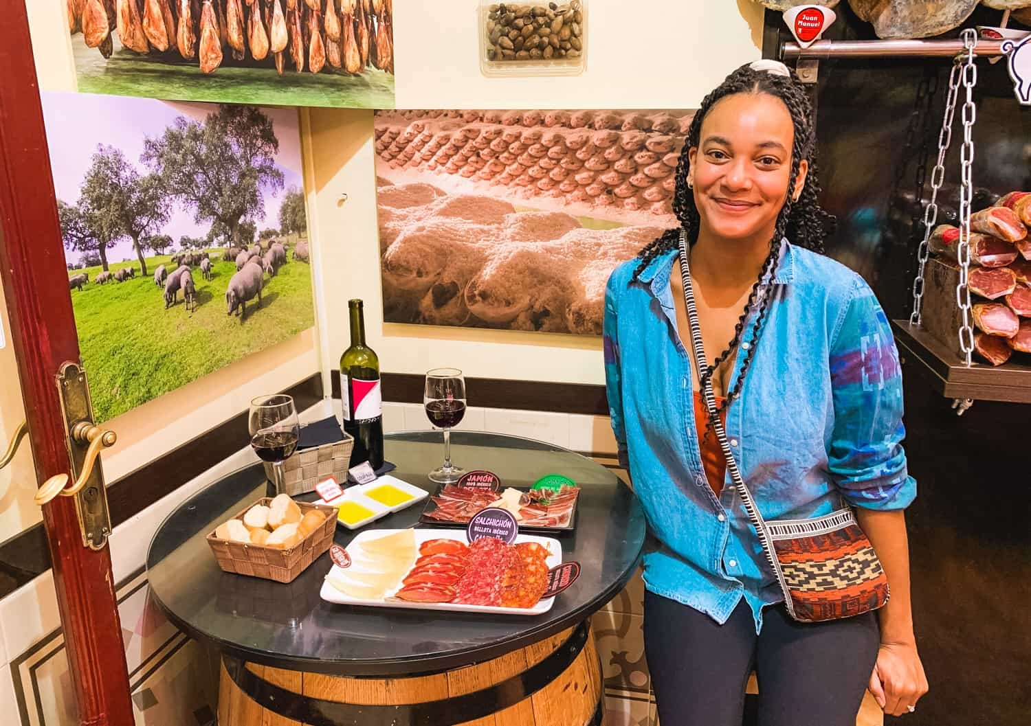 olivia eating jamon charcuterie platter in restaurant surrounded by ham