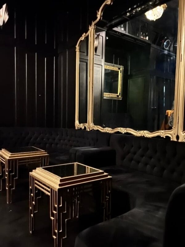 luxe interior decor, all black furniture, gold tables and mirrors