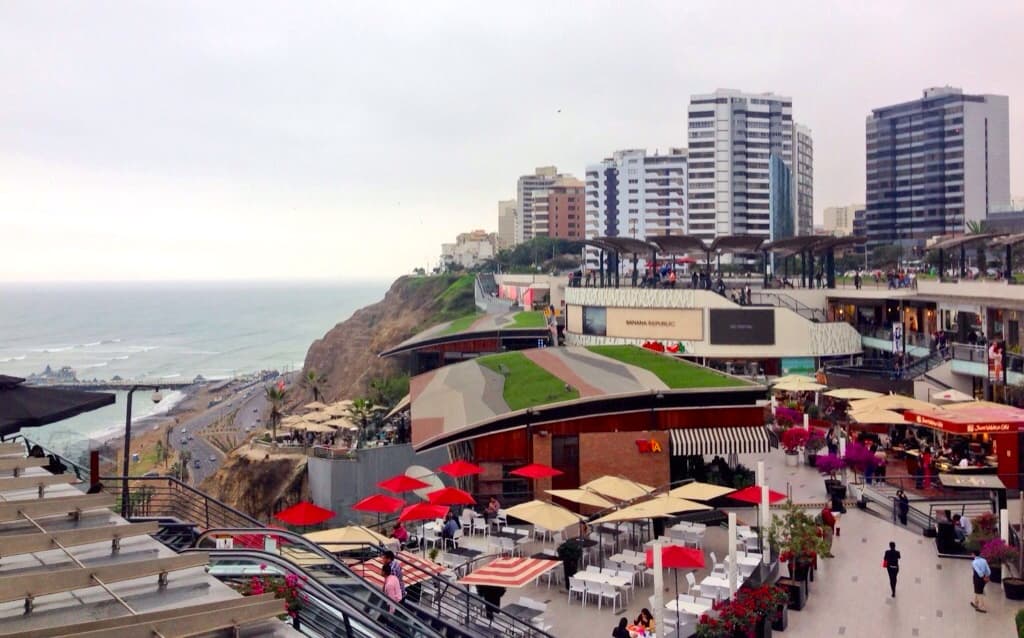 View of high-rise buildings and strip mall built on a cliff overlooking the sea on a cloudy day